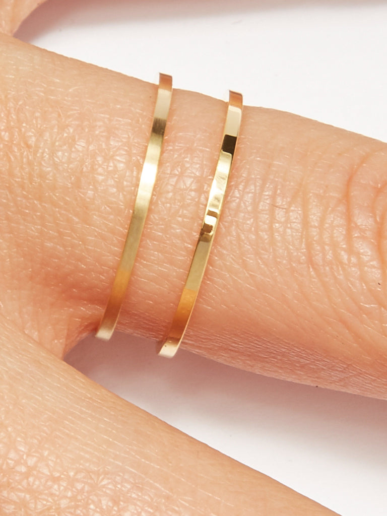 Detailed view of two Polished Gold Rings on a models finger by  Bagatiba 