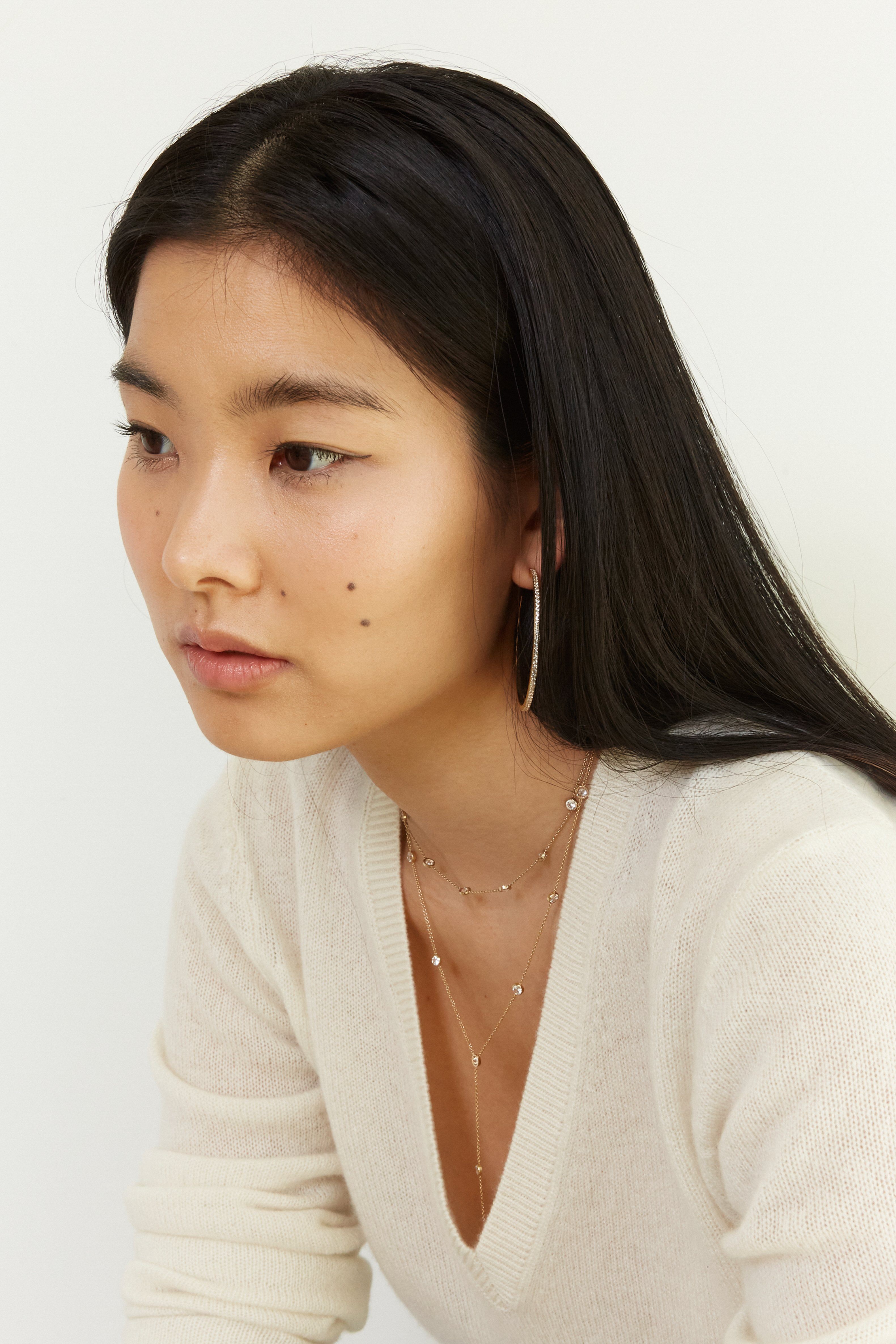 Side view of model wearing the Princess Drop Necklace by Bagatiba 