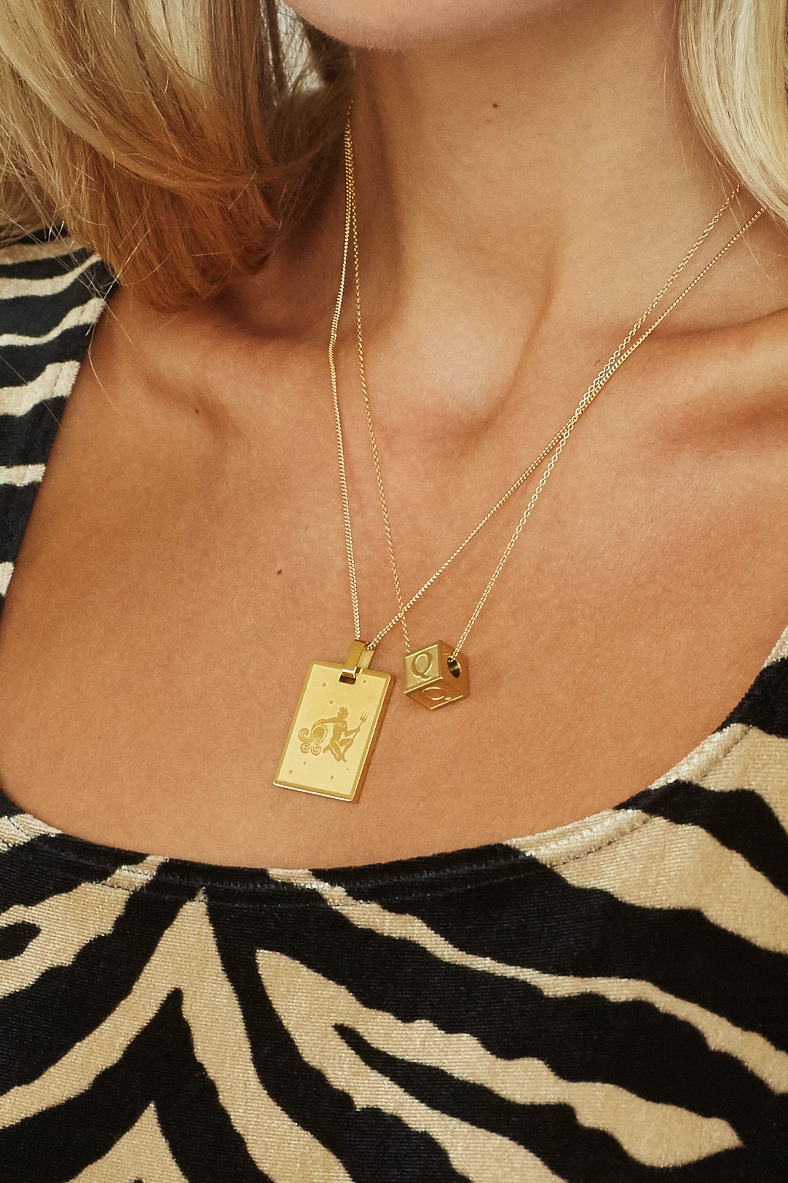 Cropped view on model "Q" Letter Block letter layered with zodiac charm on simple chains  Bagatiba 