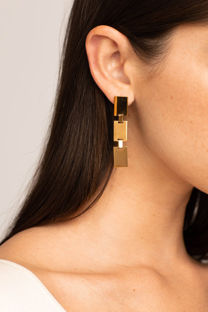 Detail view on model's ear of Rectangle Dangle Earrings by Bagatiba 