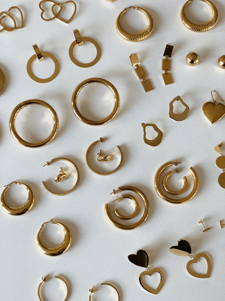 flat lay view of multiple earring styles including the Rectangle Dangle Earrings by Bagatiba 