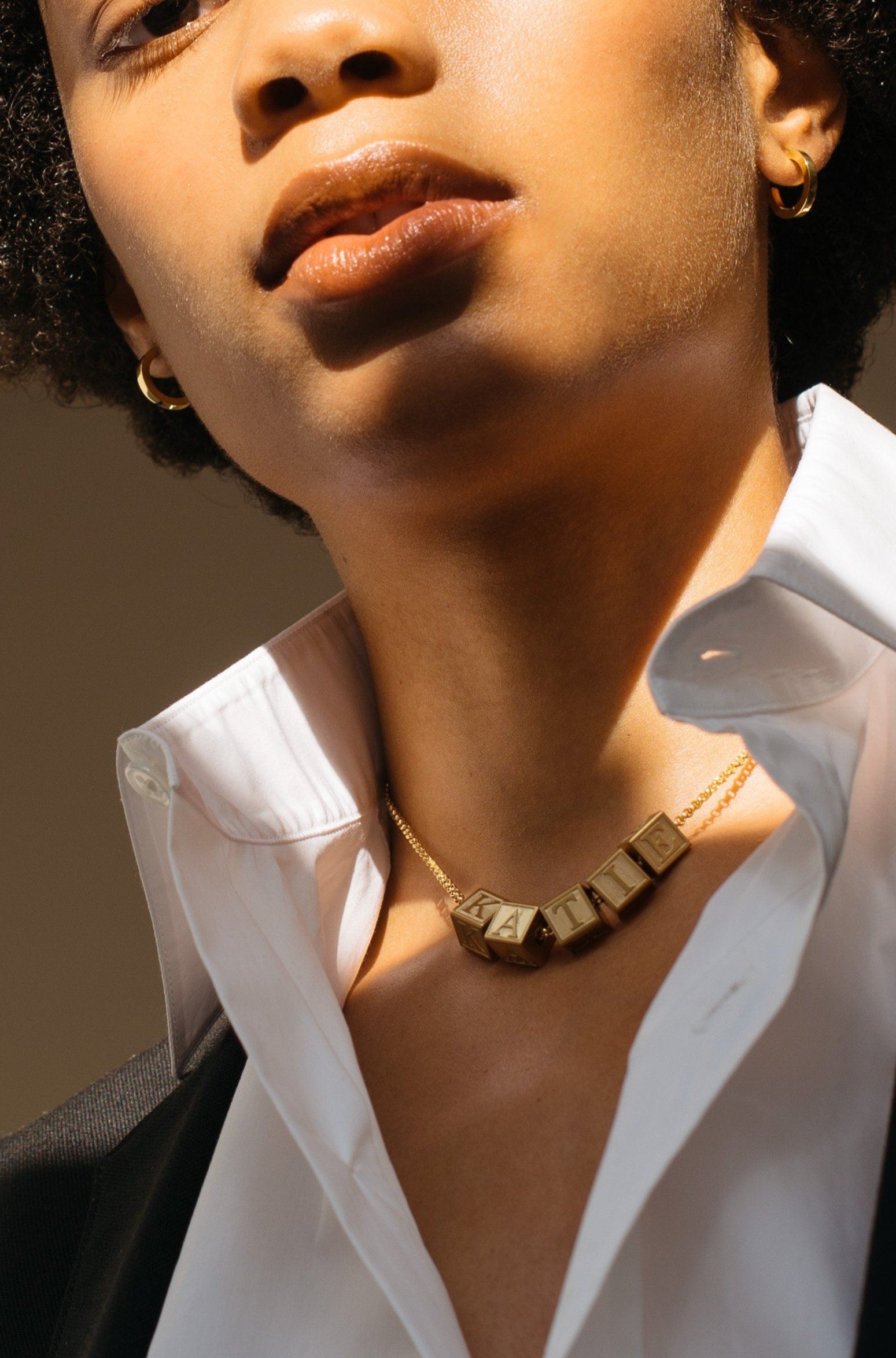 Model wearing 5 Letter Block letters on choker chain Bagatiba