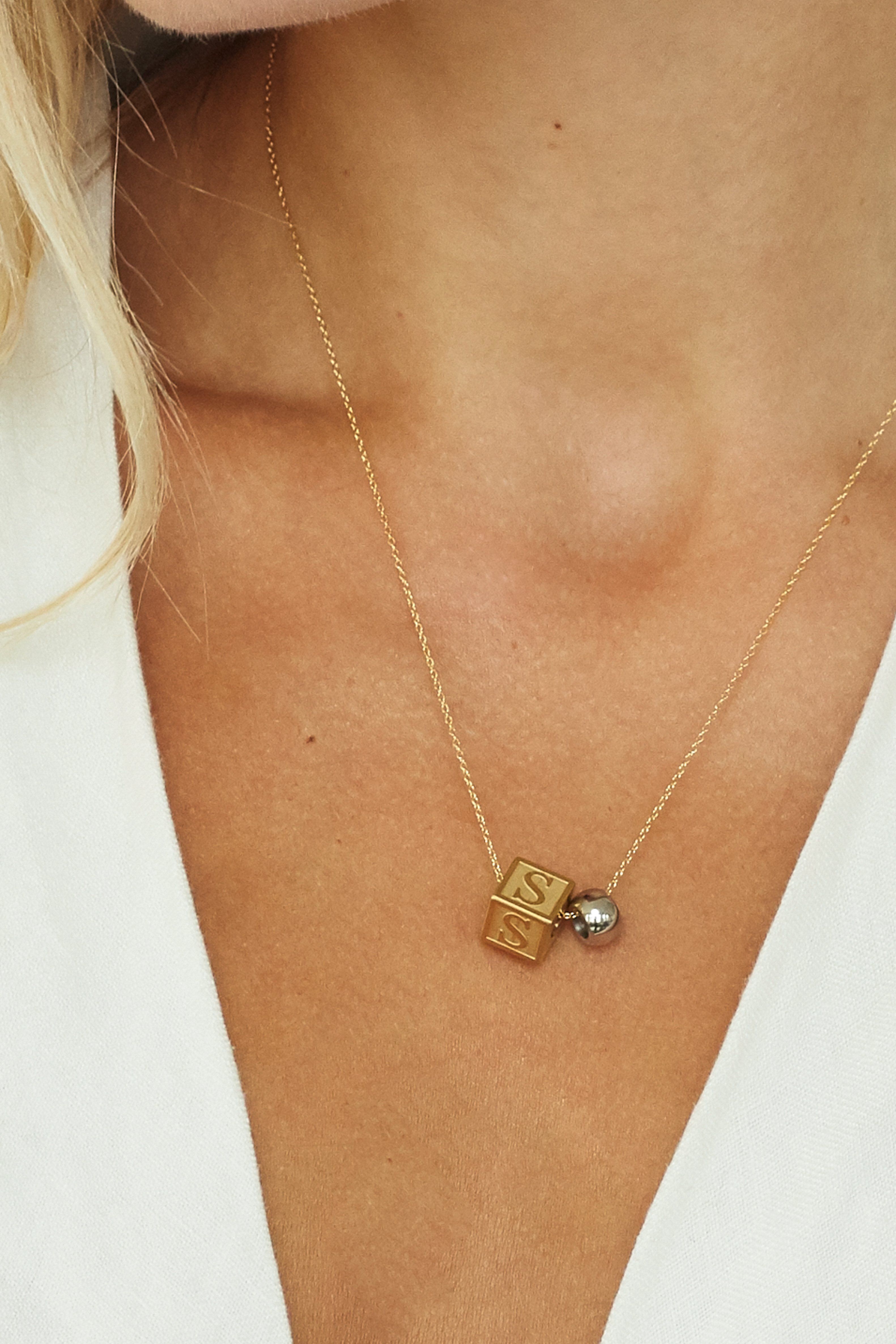 cropped view on model wearing "S" Letter Block letter with a silver bead on simple chain  Bagatiba 