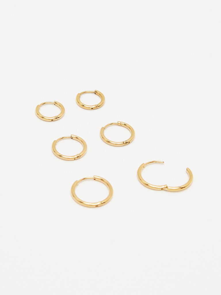 Cropped flat lay view Set of Gold Eco Huggies Earrings Bagatiba 