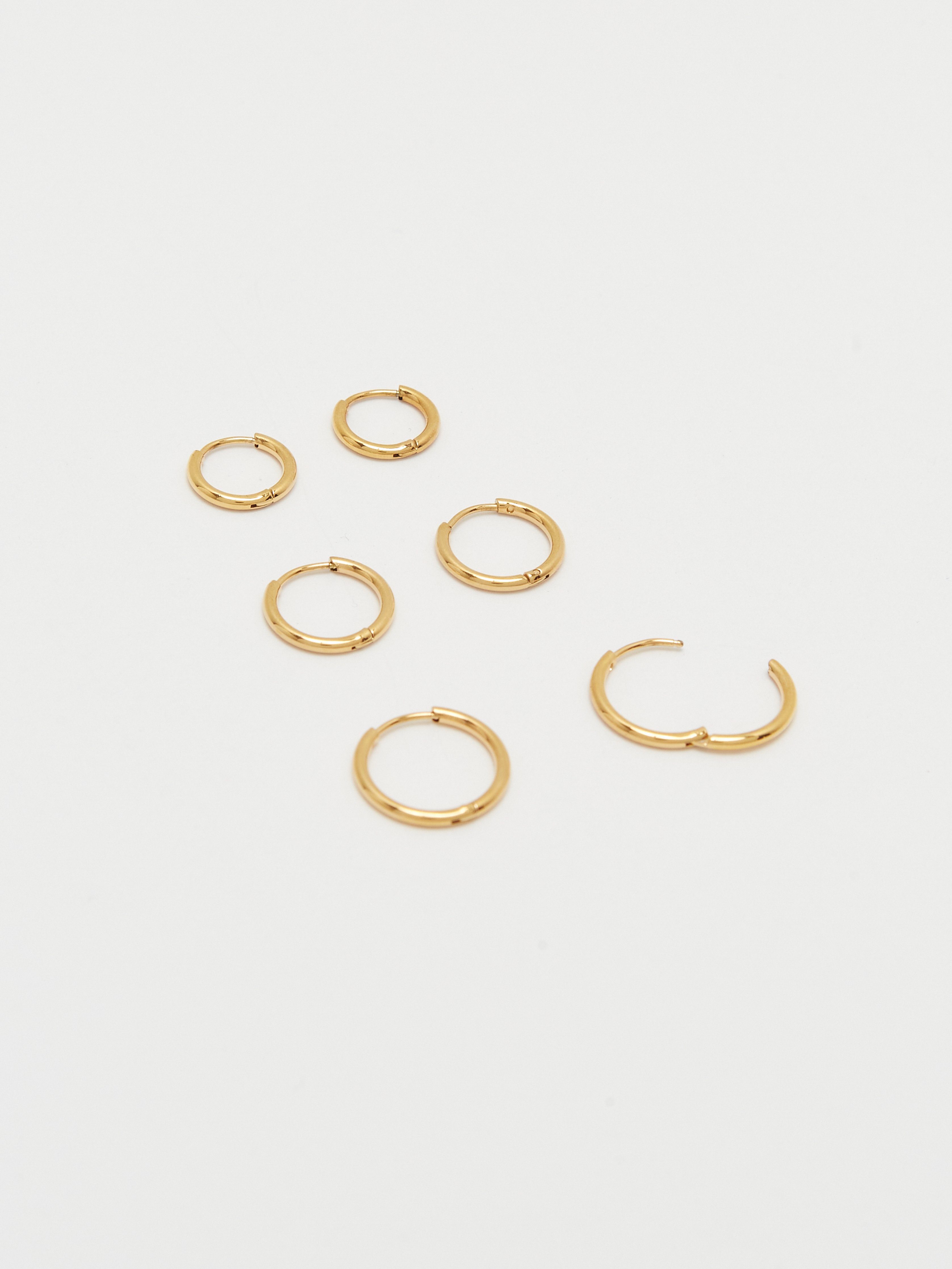 Detail view flat lay Set of Gold Eco Huggies Earrings Bagatiba 