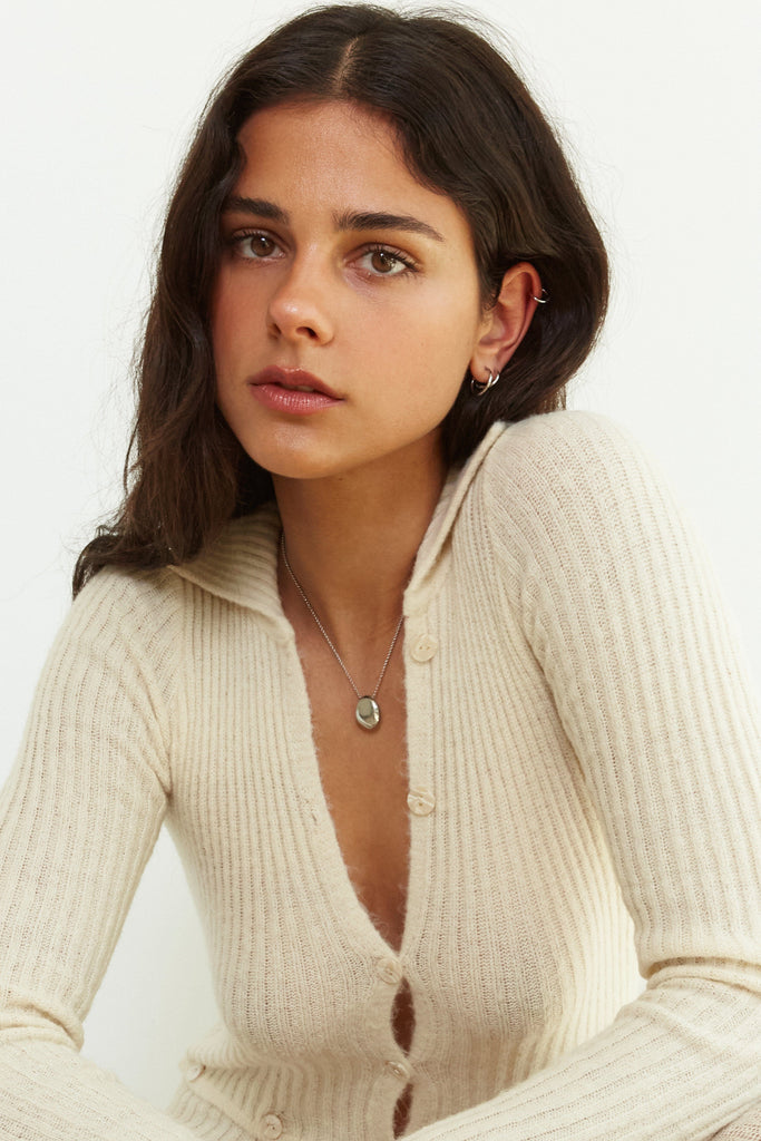 Model wearing the Set of Silver Eco Huggie Hoops Earrings paired with the silver mini orb necklace  Bagatiba 
