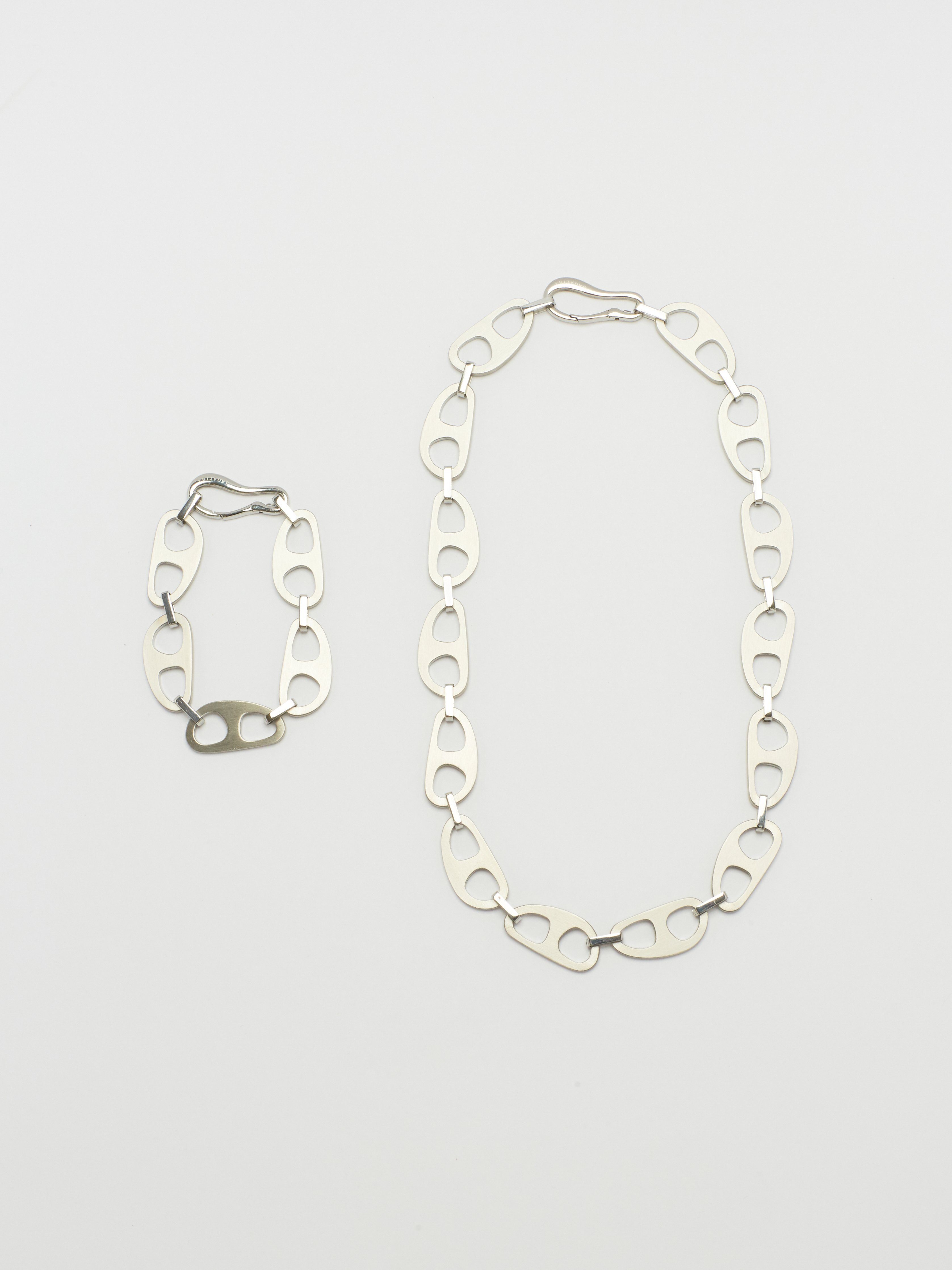 Full view flat lay of Silver Brushed Tab Bracelet and Necklace by  bagatiba 