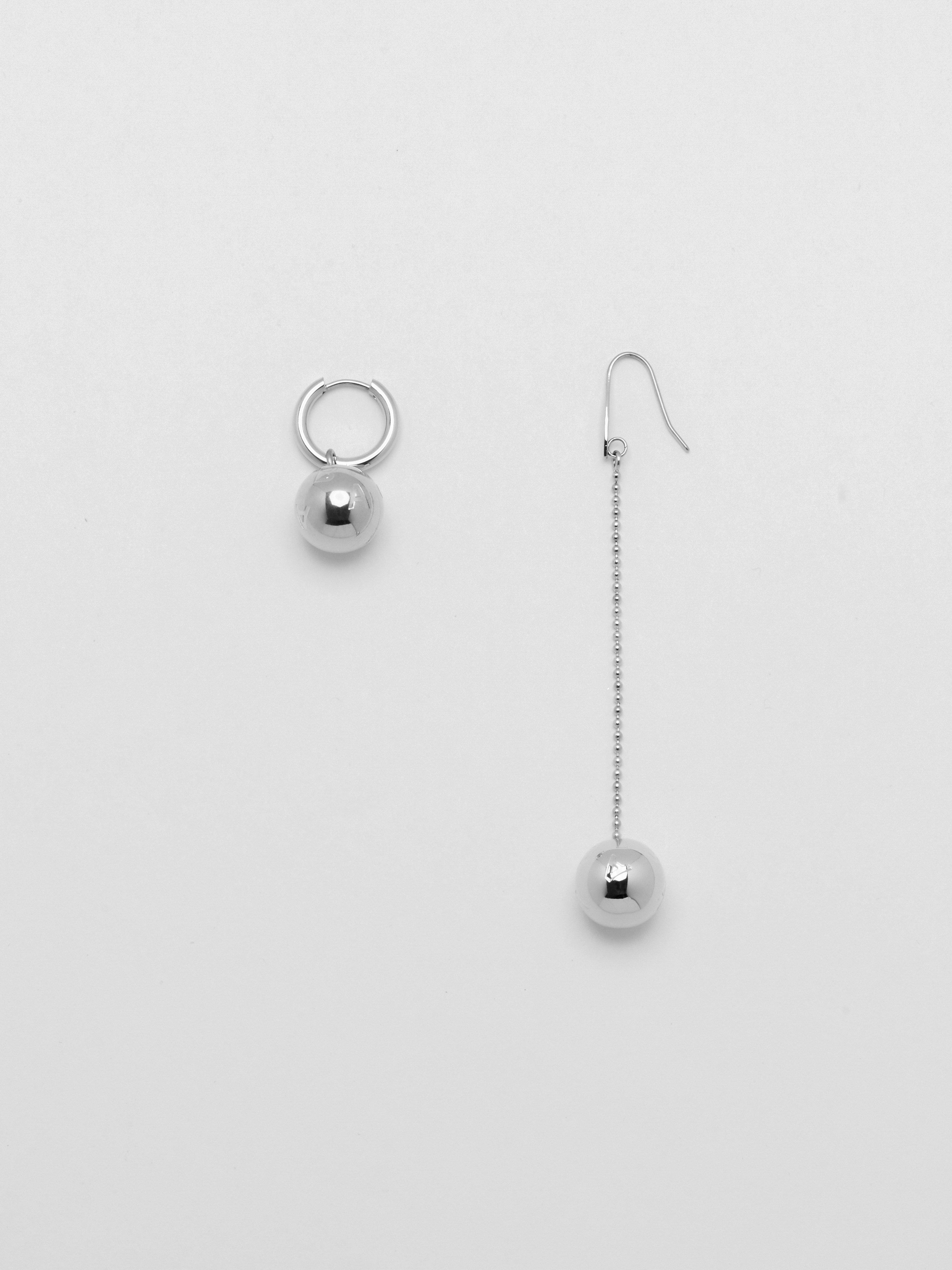 Flat lay of Silver Drop Sphere Earring and Silver Sphere Hoop  Earrings bagatiba 