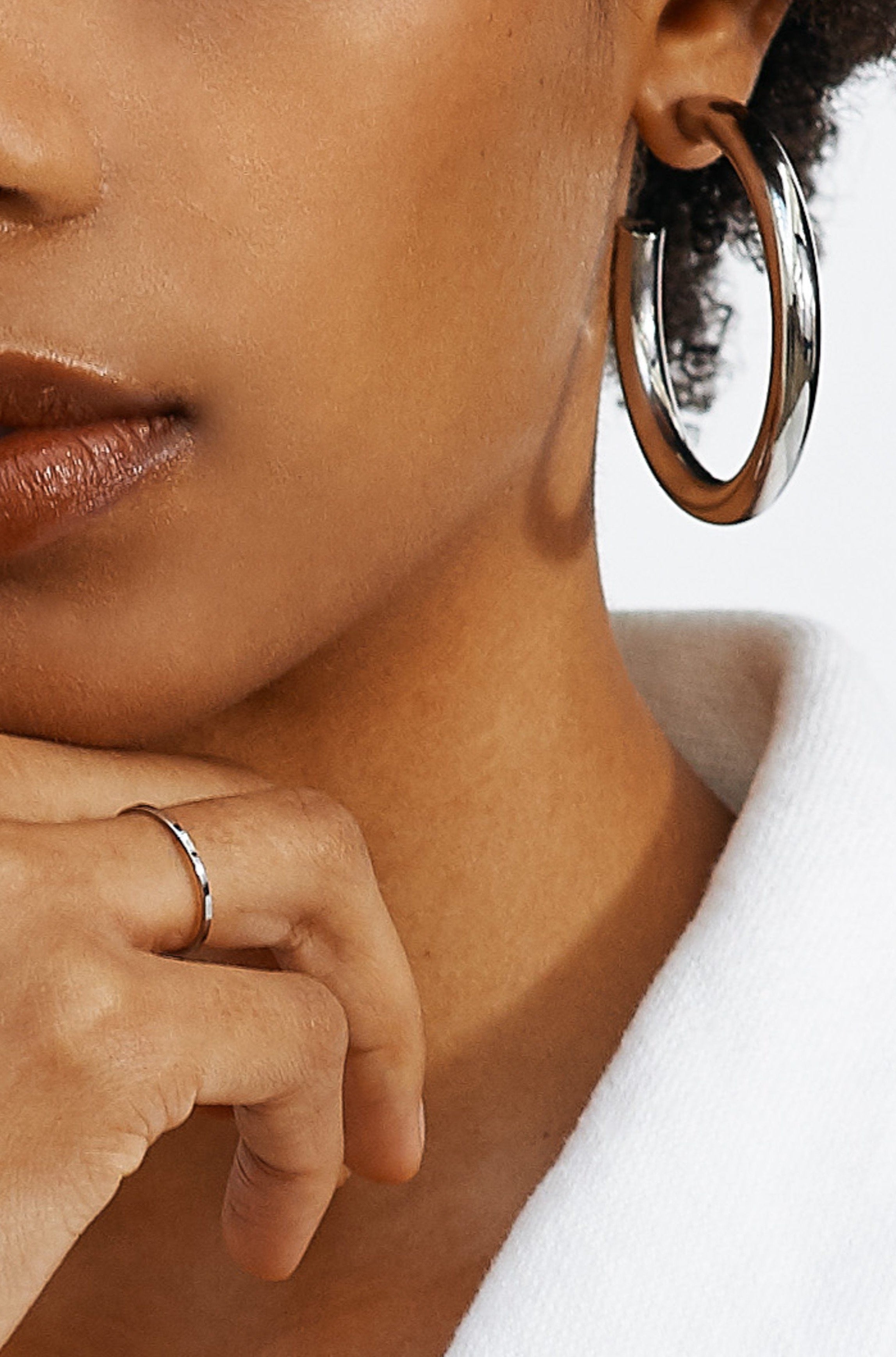 Cropped view on model of Silver Hollow Hoops Earrings Bagatiba 