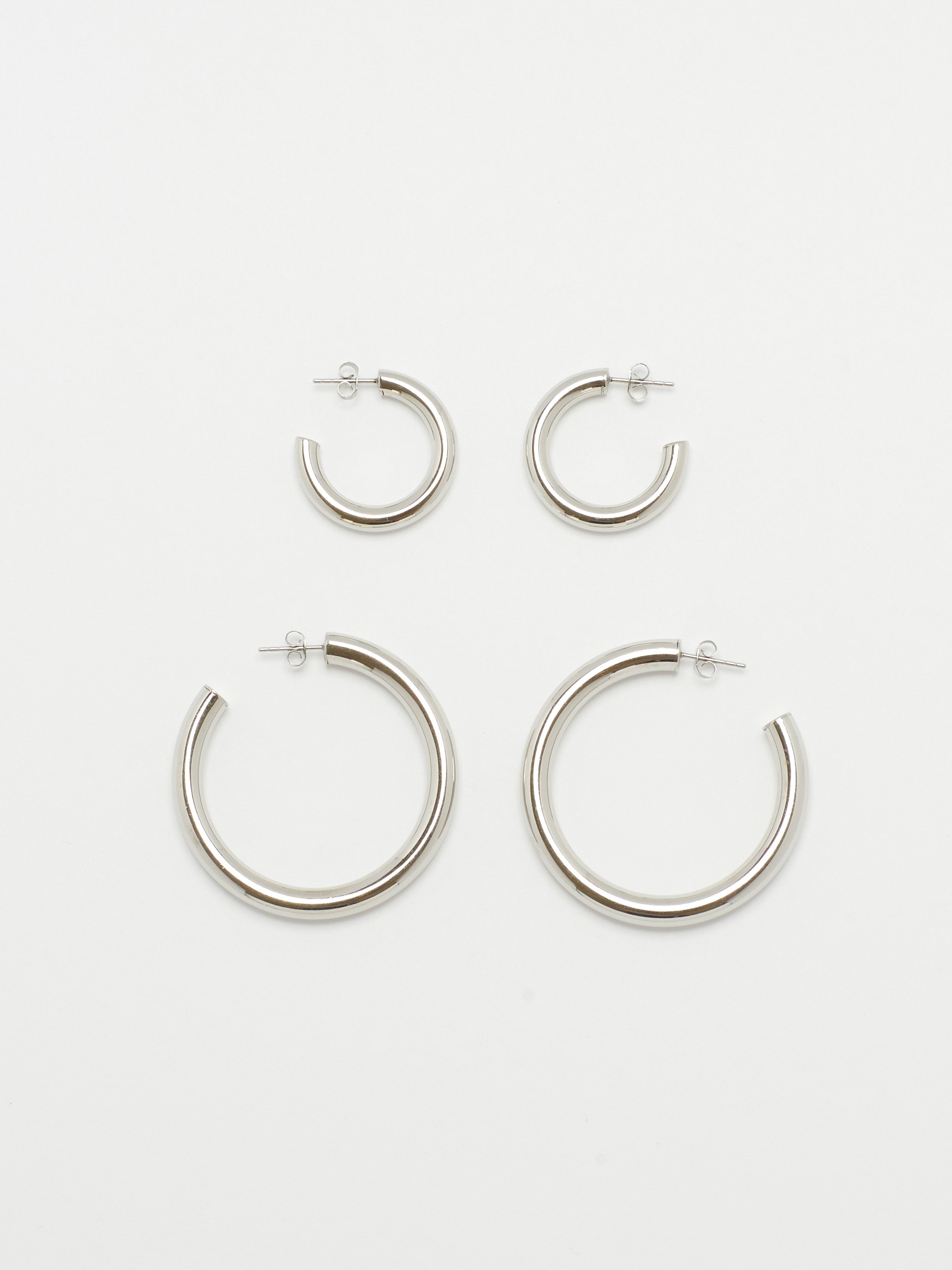 Full view flat lay of Silver Hollow Hoops and Mini Silver Hollow Hoops Earrings Bagatiba 