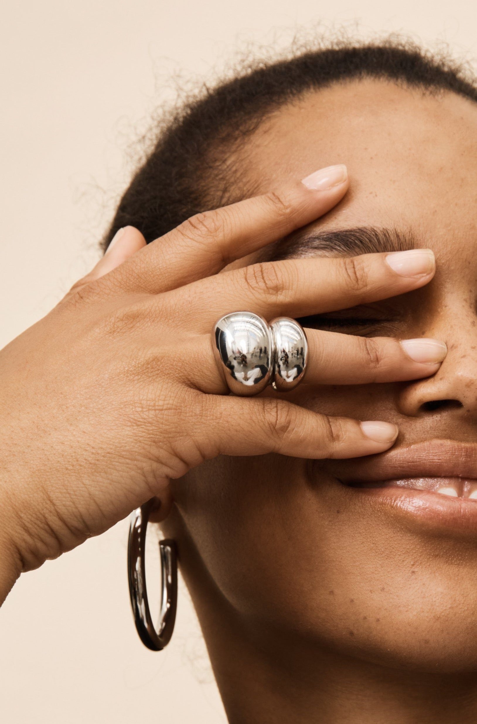 Model wearing the Silver Hollow Hoops Earrings and Silver Orb Rings  by Bagatiba 