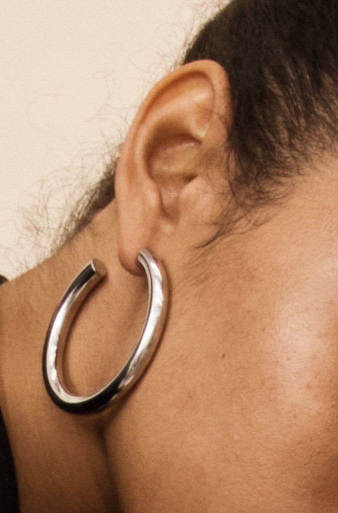 Model wearing the Silver Hollow Hoops Earrings paired with Silver Orb Rings by Bagatiba 