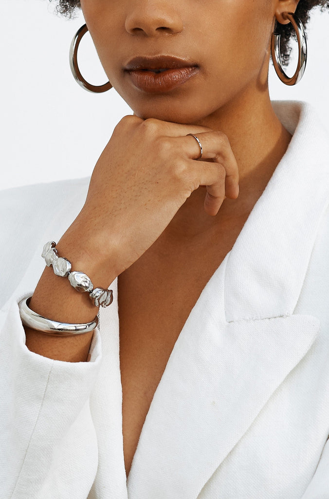 Model wearing the Silver Orb Cuff Bracelet by bagatiba styled with a white blazer