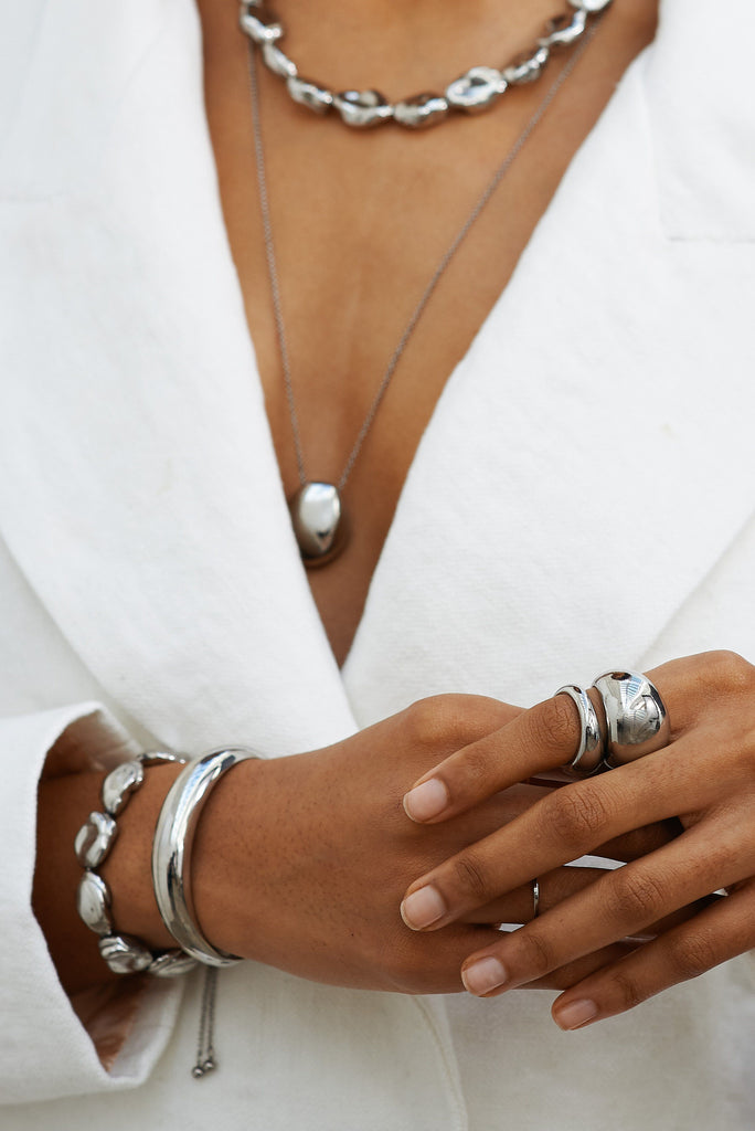 Cropped detail view of model's torso wearing Silver Orb Cuff Bracelet paired with other Silver items by bagatiba 