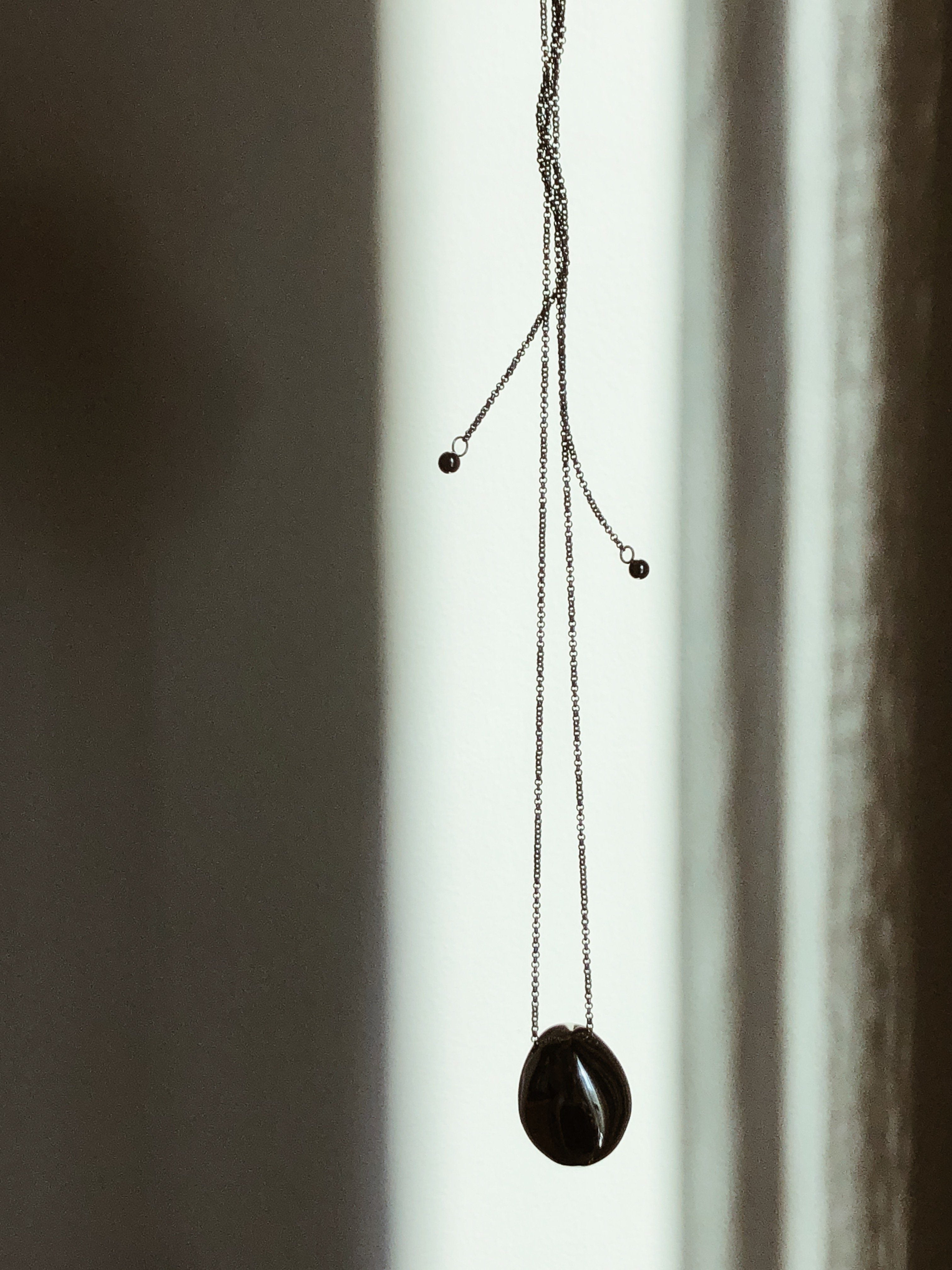 Silver Orb Necklace by bagatiba shown in natural light