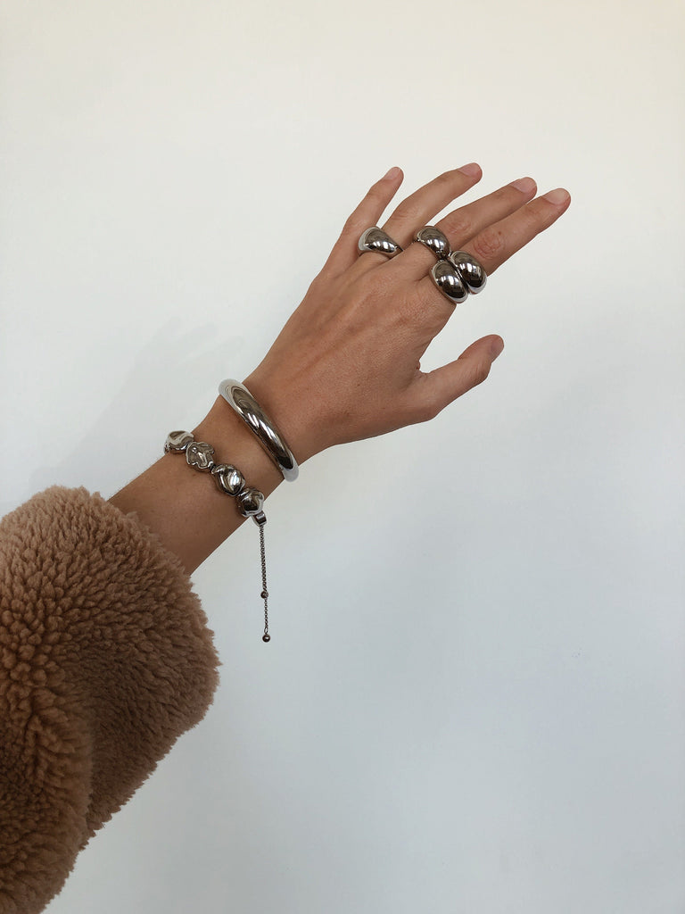 Detailed view of model's wrist and hand styled with Silver Pearl Bracelet and other silver items by  bagatiba 