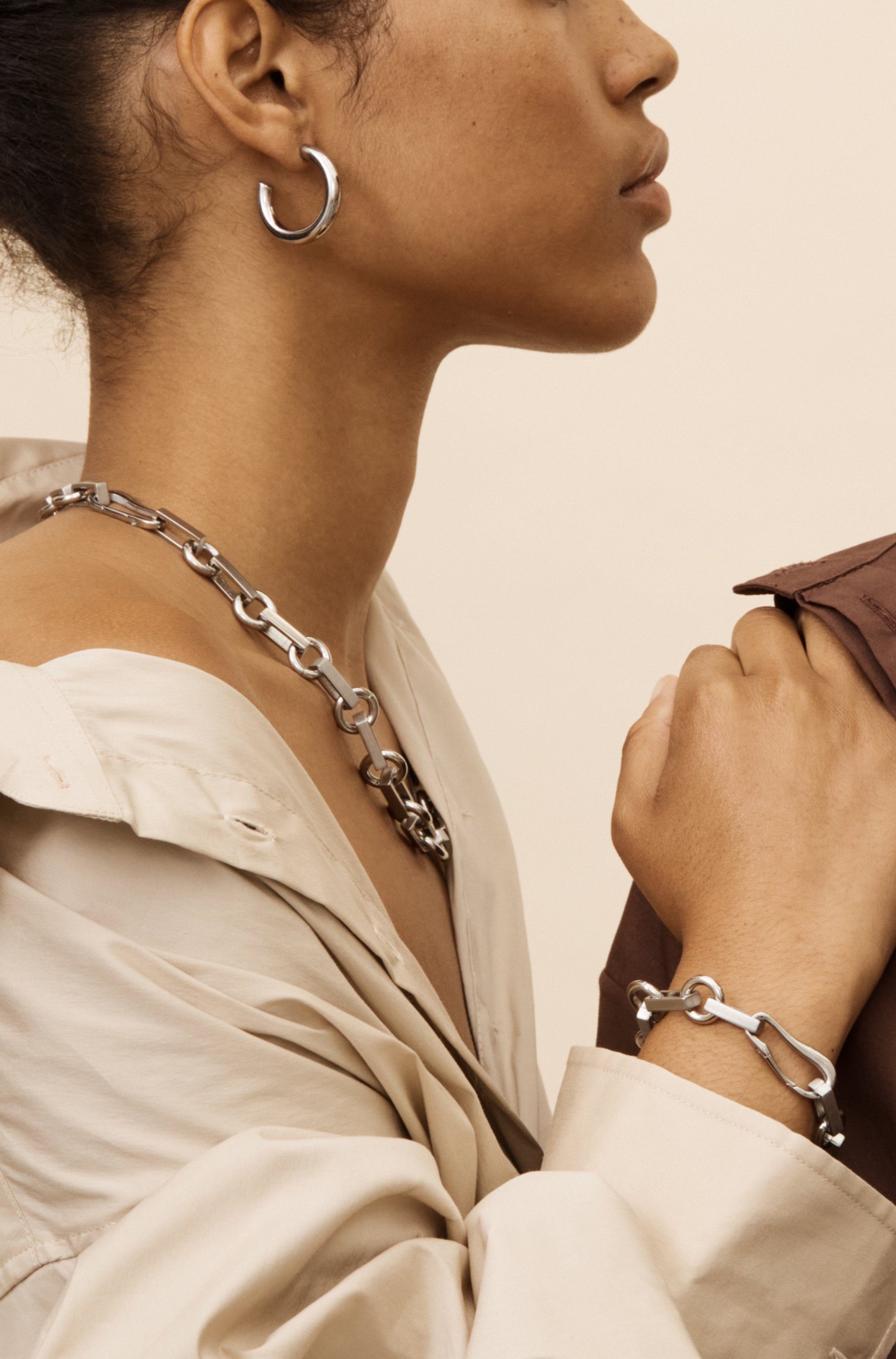 Side profile view of model in Silver Tilda Bracelet and Necklace by bagatiba 