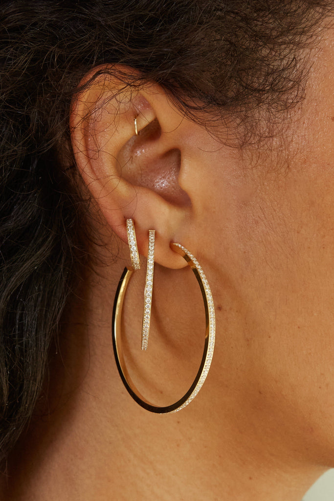 Close up view on model's ear of Small Diamond Hoops Earrings Bagatiba 