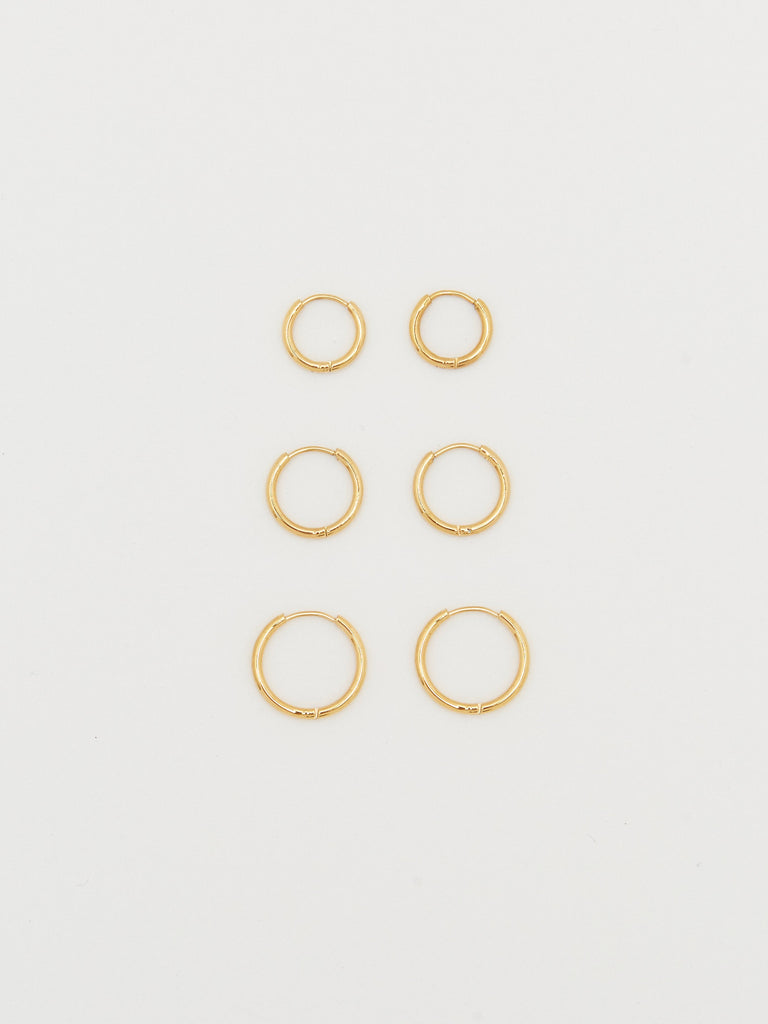 Full view flat lay of the Small, Medium & Large  Gold Eco Huggies Earrings Bagatiba 