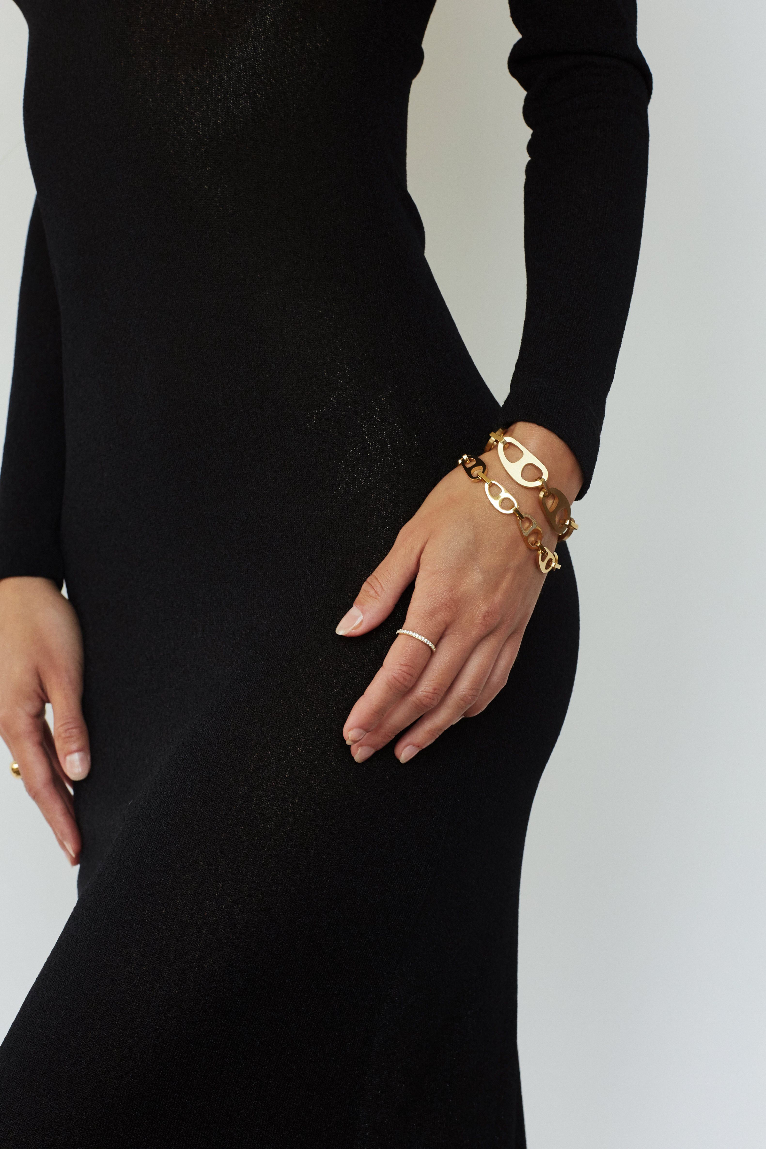 Small Gold Tab Bracelet and Brushed Gold Tab Bracelet by bagatiba shown on model's wrist