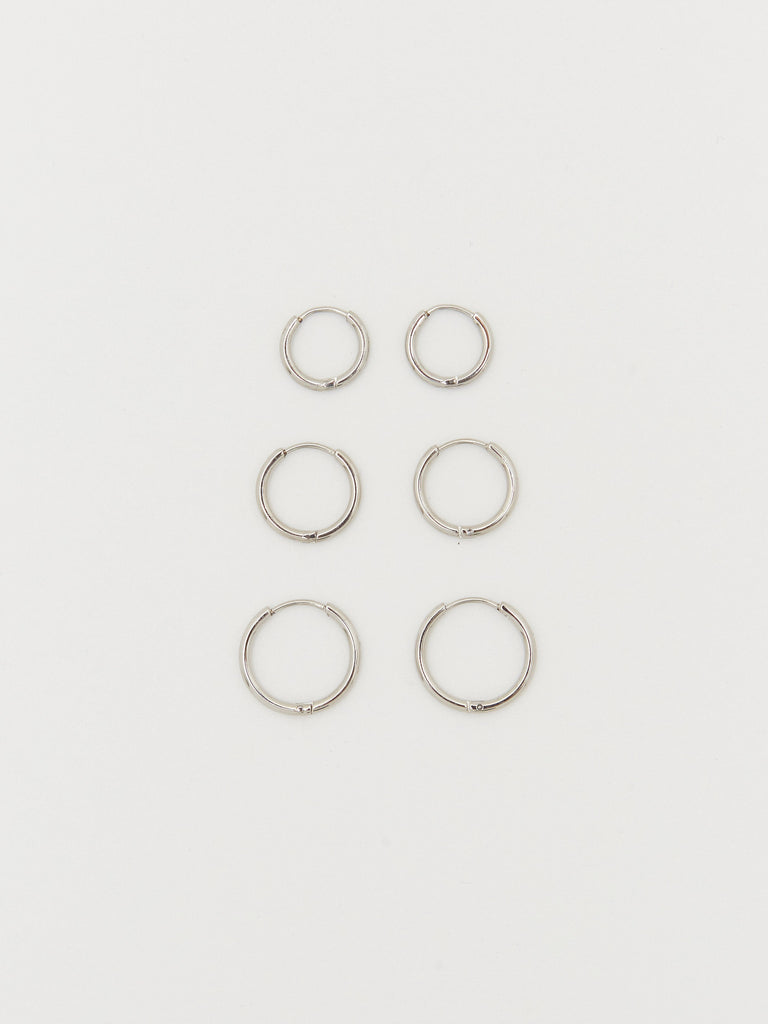 Flat lay view of Small, Medium and Large Silver Eco Huggies Earrings Bagatiba 
