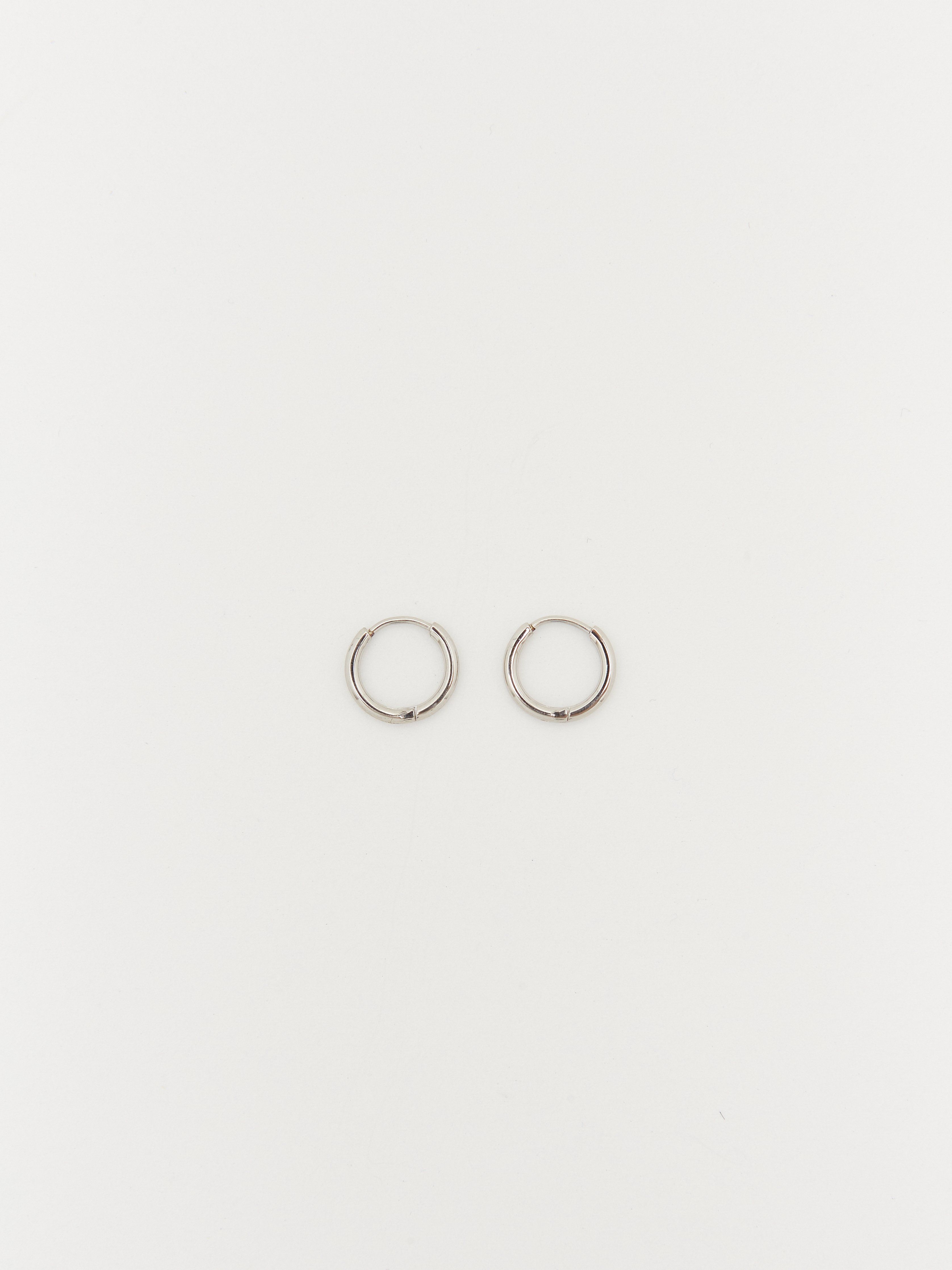 Full view flat lay of Small Silver Eco Huggies Earrings Bagatiba 