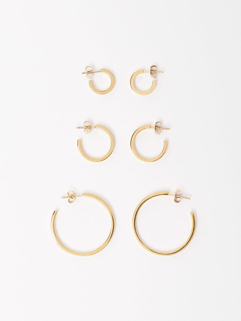 Full view flat lay of Mini Simple, Small Simple and Simple Gold Hoops Earrings Bagatiba 