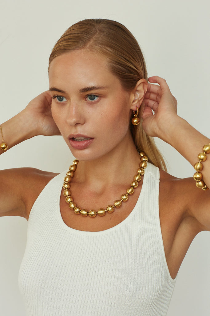Model wearing the Sphere Collection including the Hoops Earrings by bagatiba 