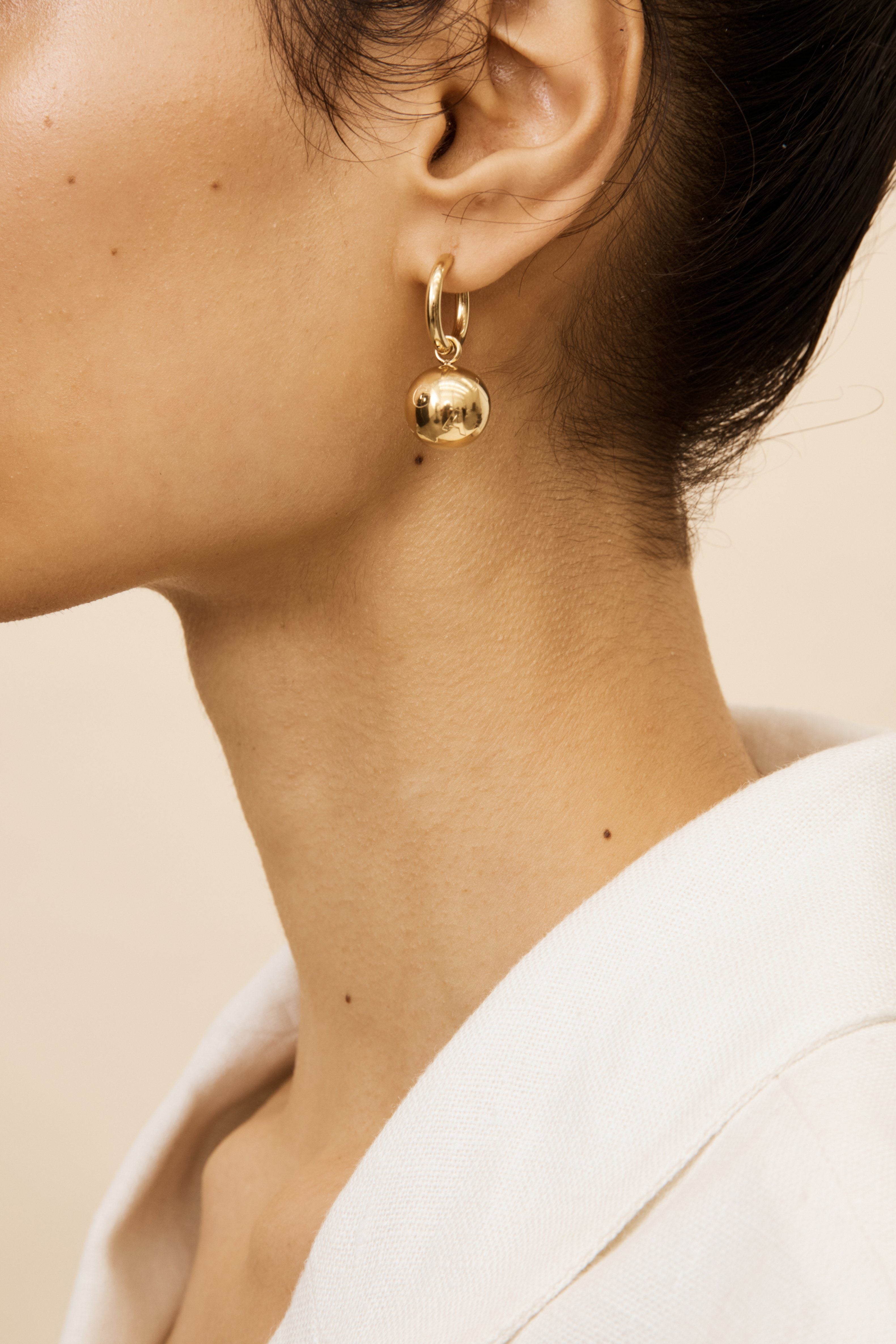 Side profile view of model's ear with the Sphere Hoops Earrings bagatiba 