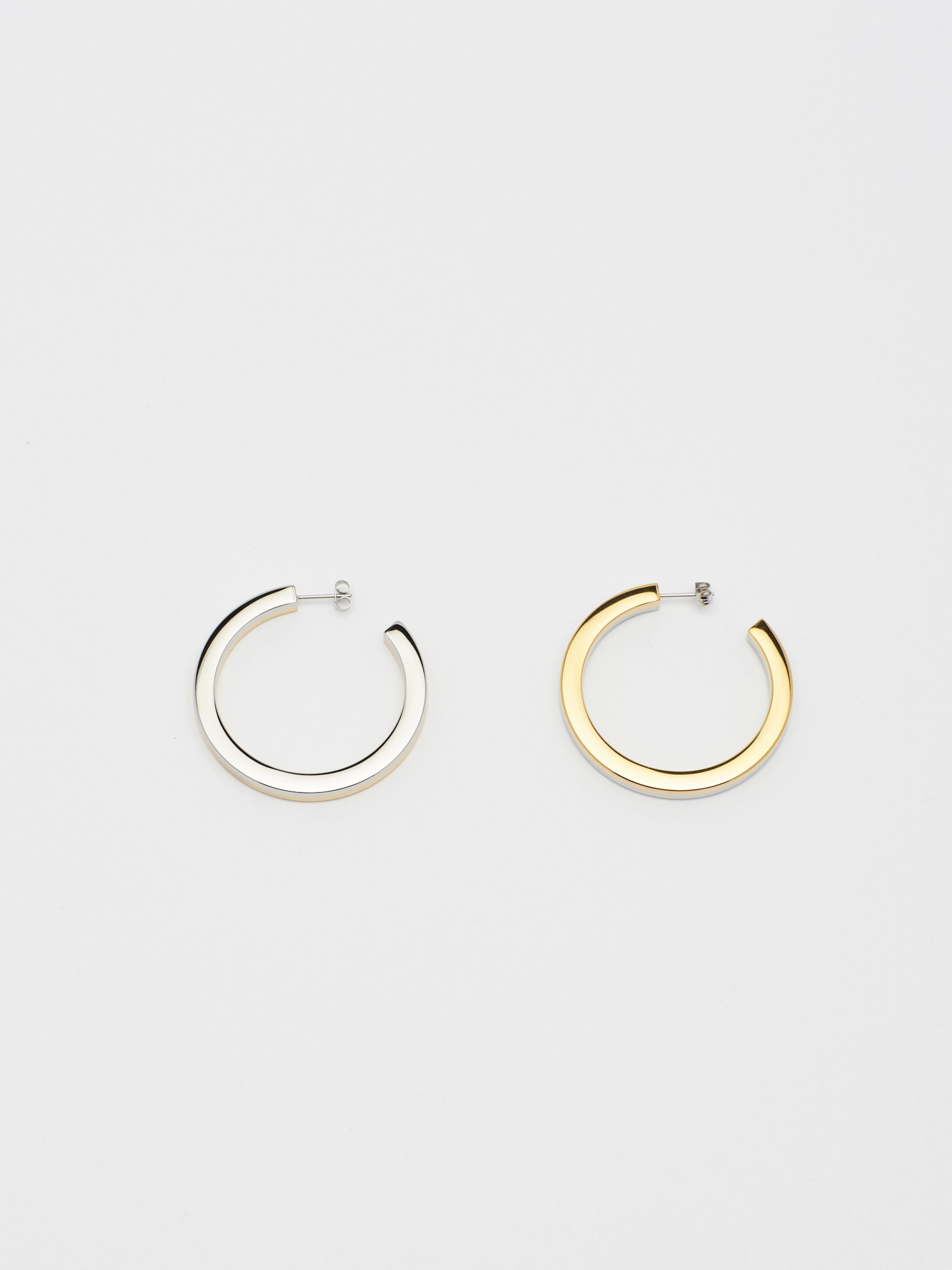 Flat lay overhead view of Two Tone Flat Hollow Hoops Earrings Bagatiba 