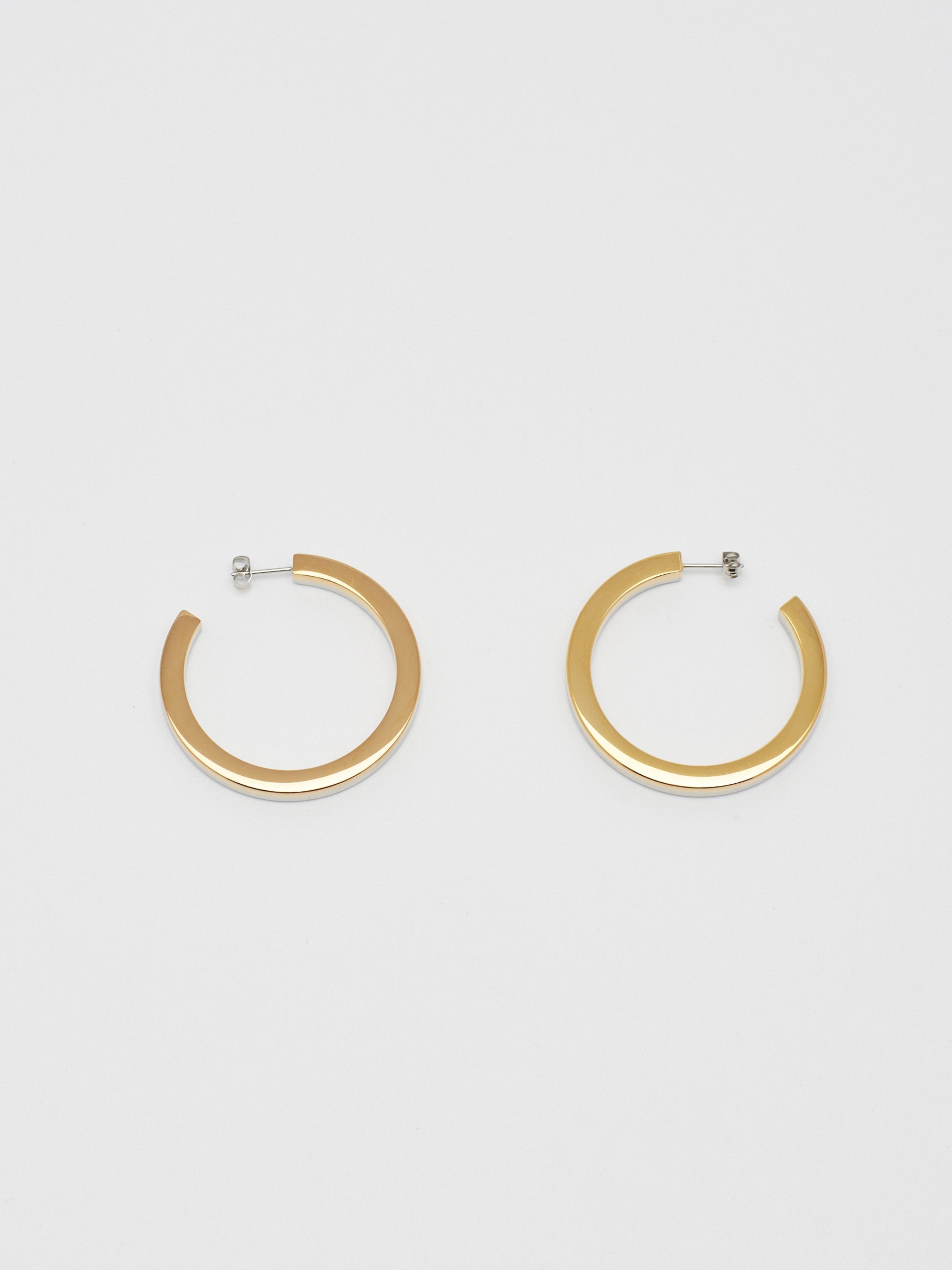 Flat lay view Two Tone Flat Hollow Hoops Earrings Bagatiba 