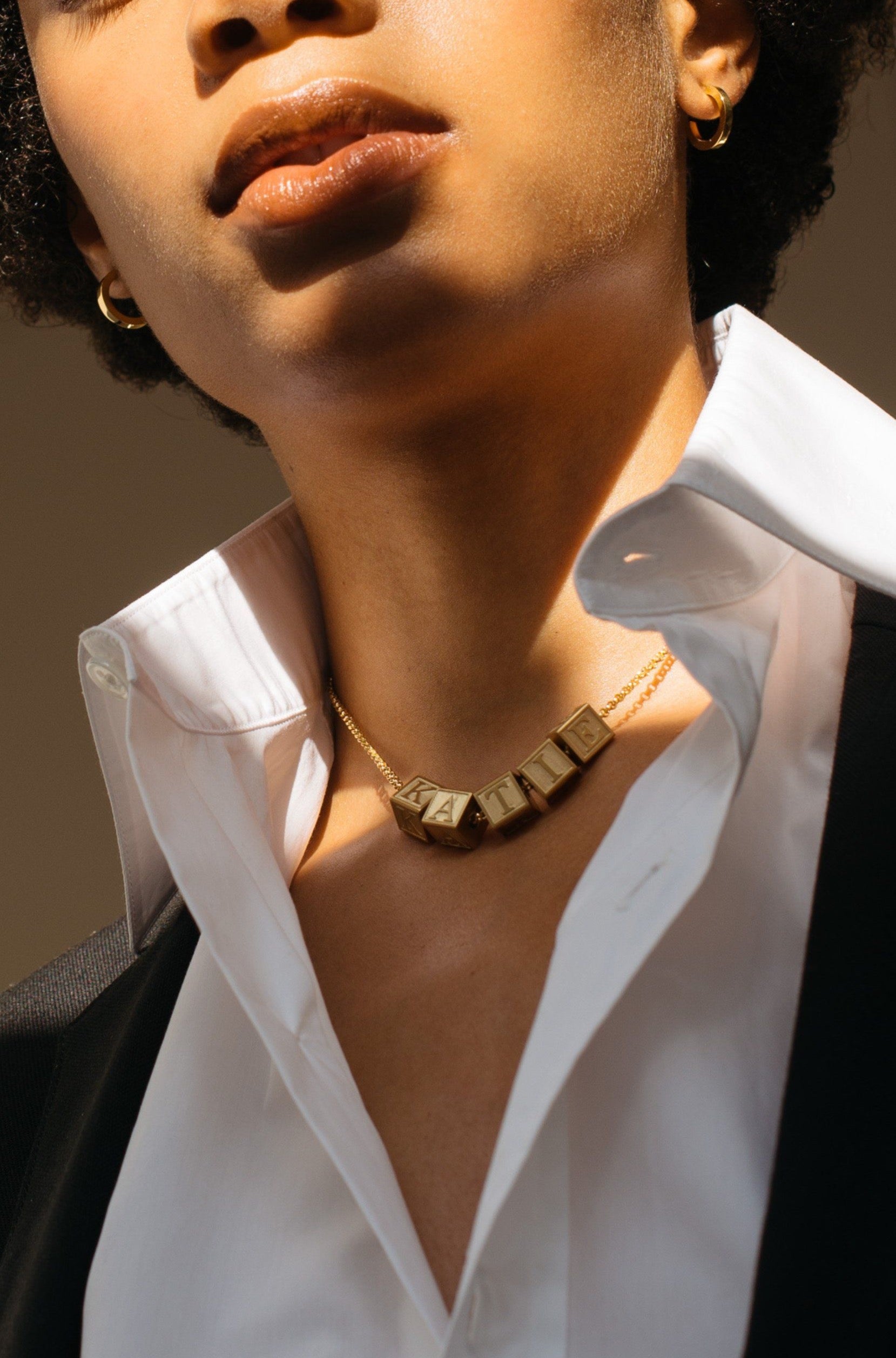 Model wearing 5 Letter Block letters on choker chain Bagatiba