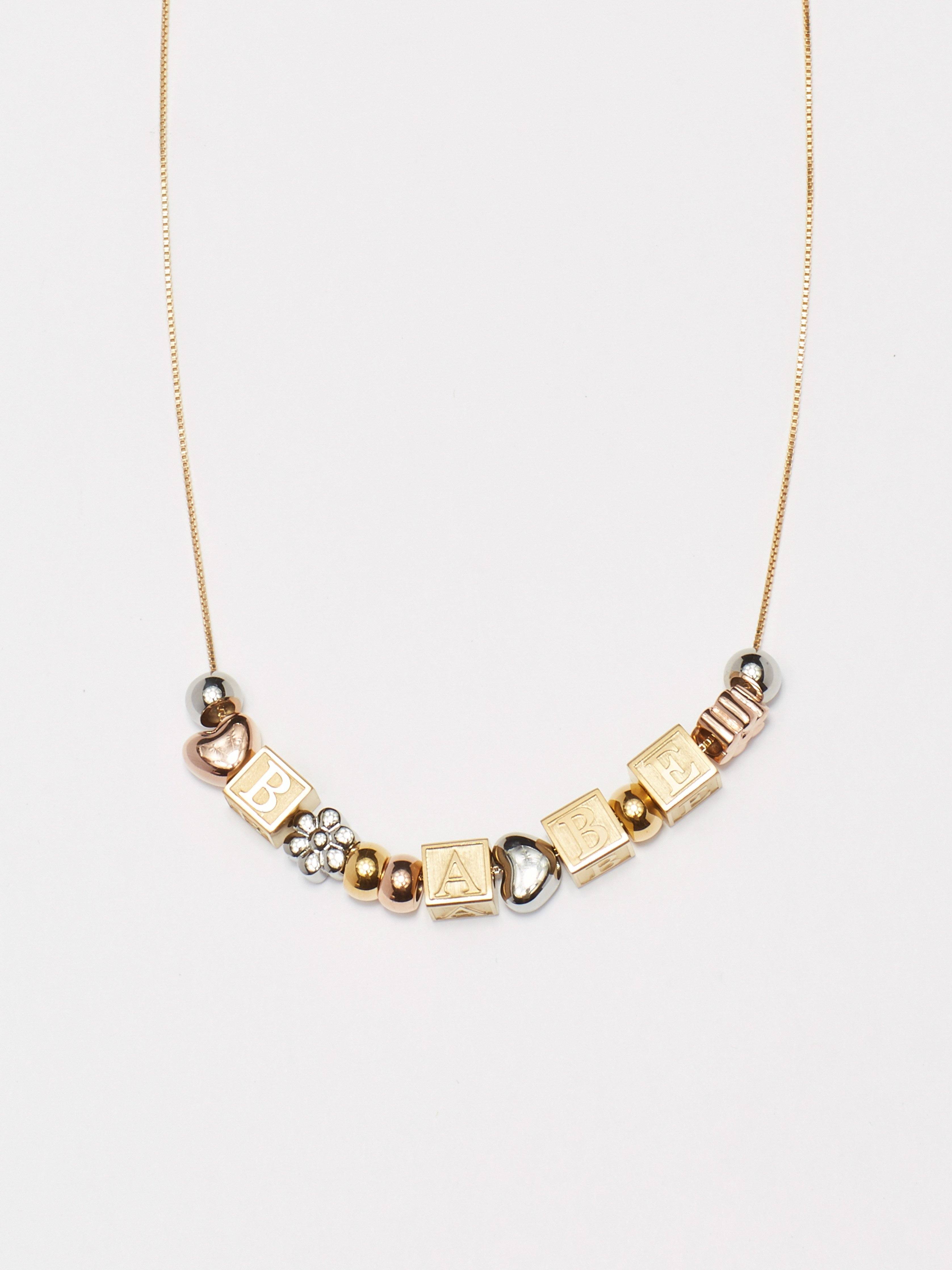 close up flat lay of "B" "A" "B" "E" Letter Block letters on chain with mixed beads Bagatiba