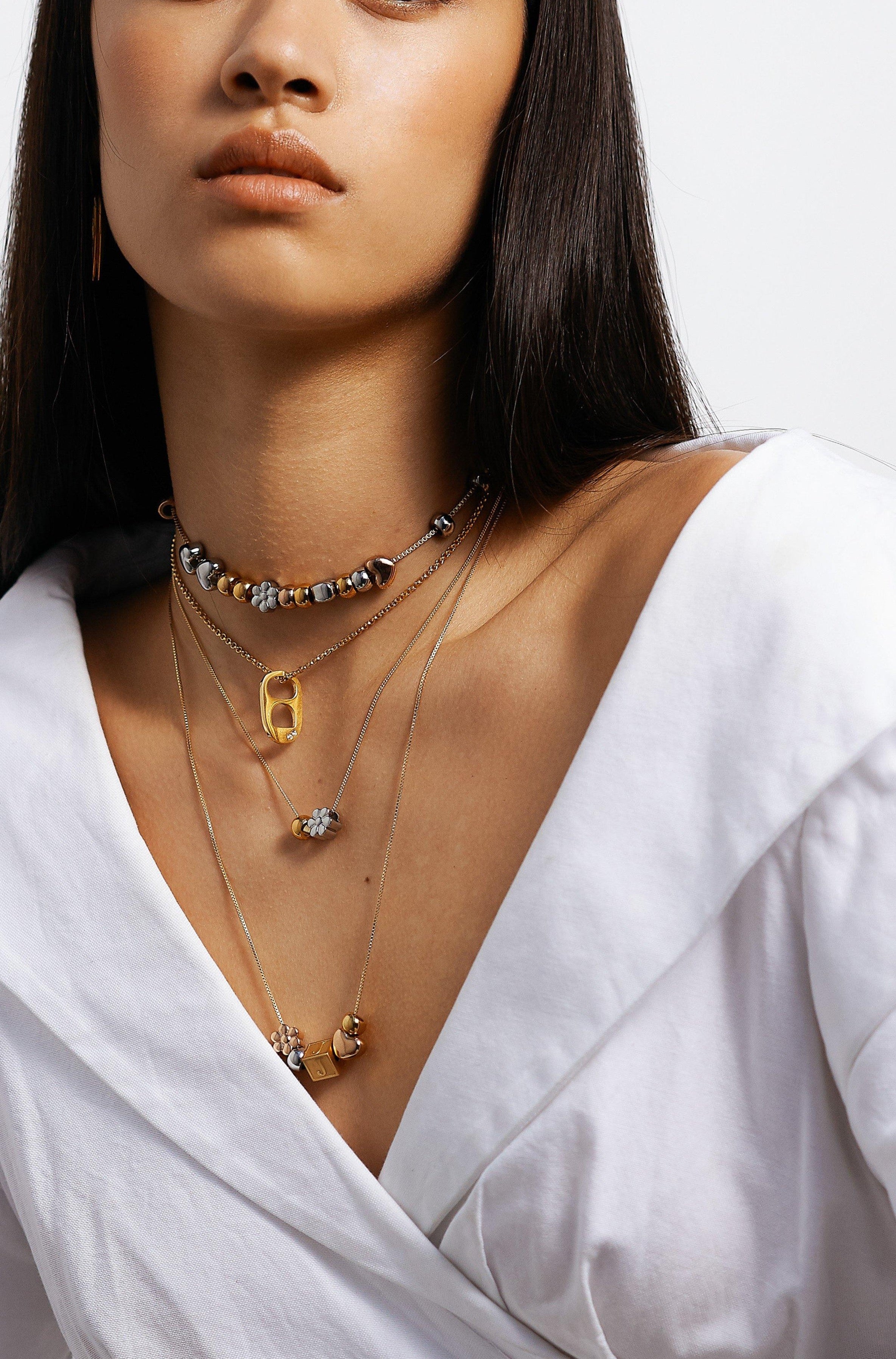 Model wearing 4 custom build it necklaces Bagatiba 