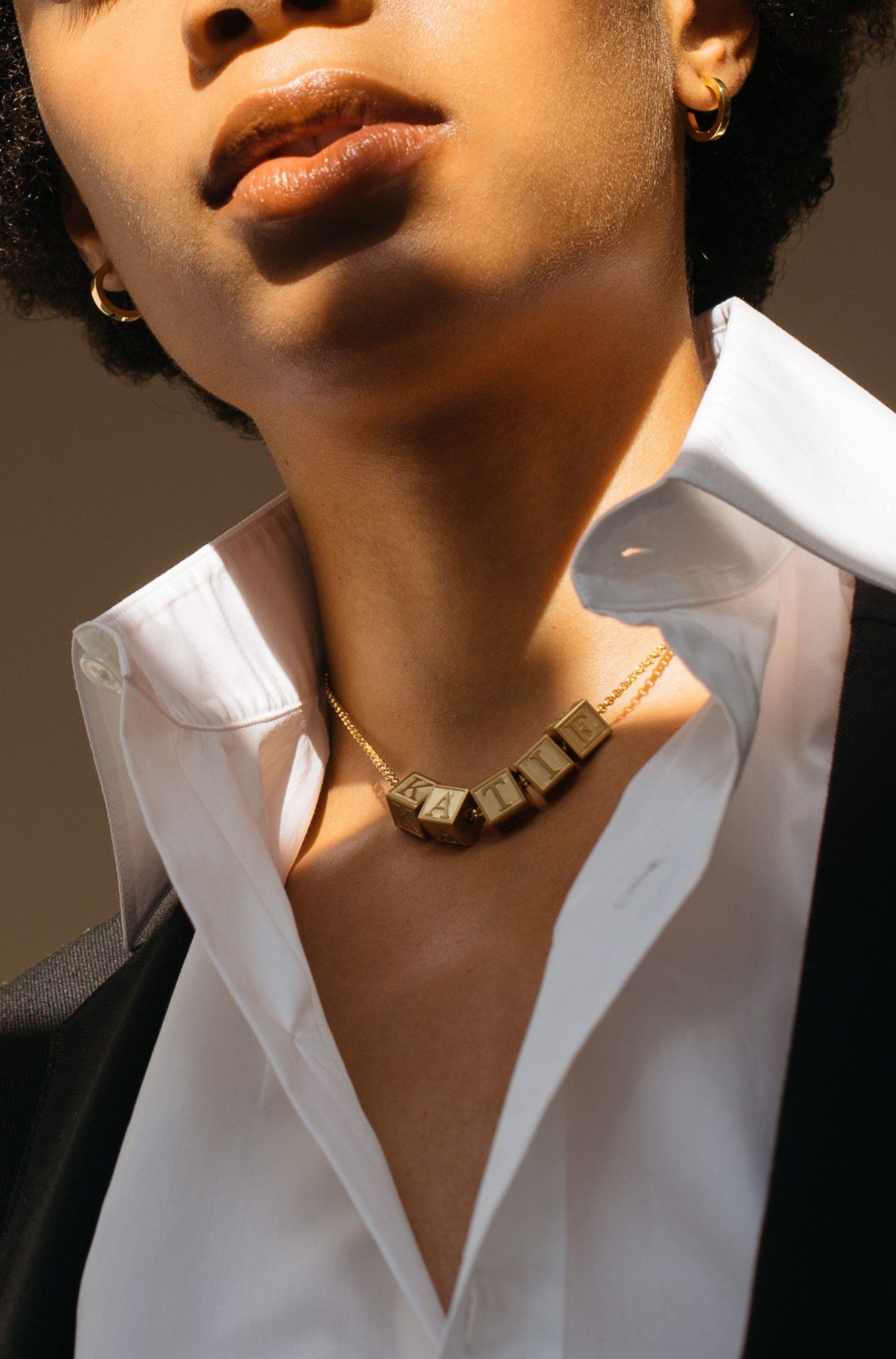 Model wearing 5 Letter Block letters on choker chain Bagatiba
