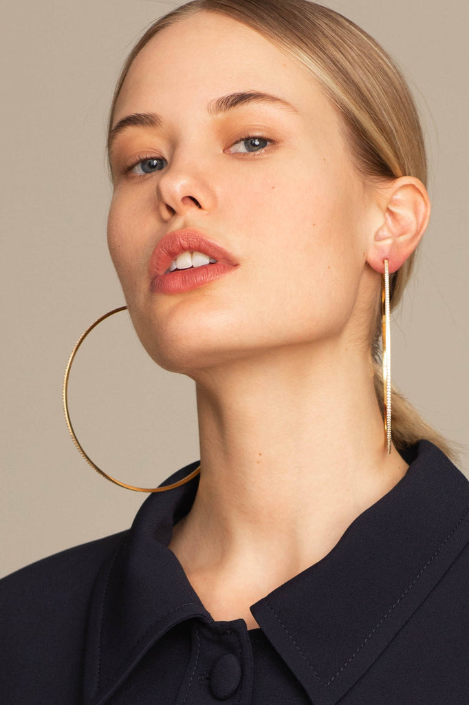 Model profile view wearing the XL Oversized Diamond Hoops Earrings Bagatiba 
