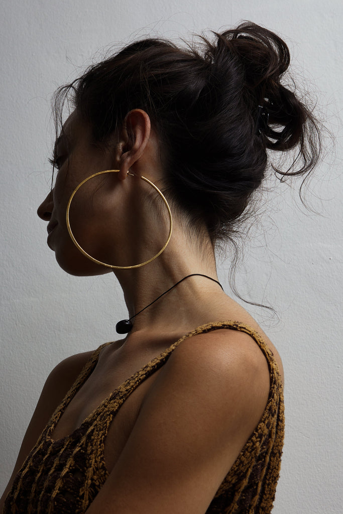 Model wearing the XL Oversized Simple Gold Hoops Earring Bagatiba side profile