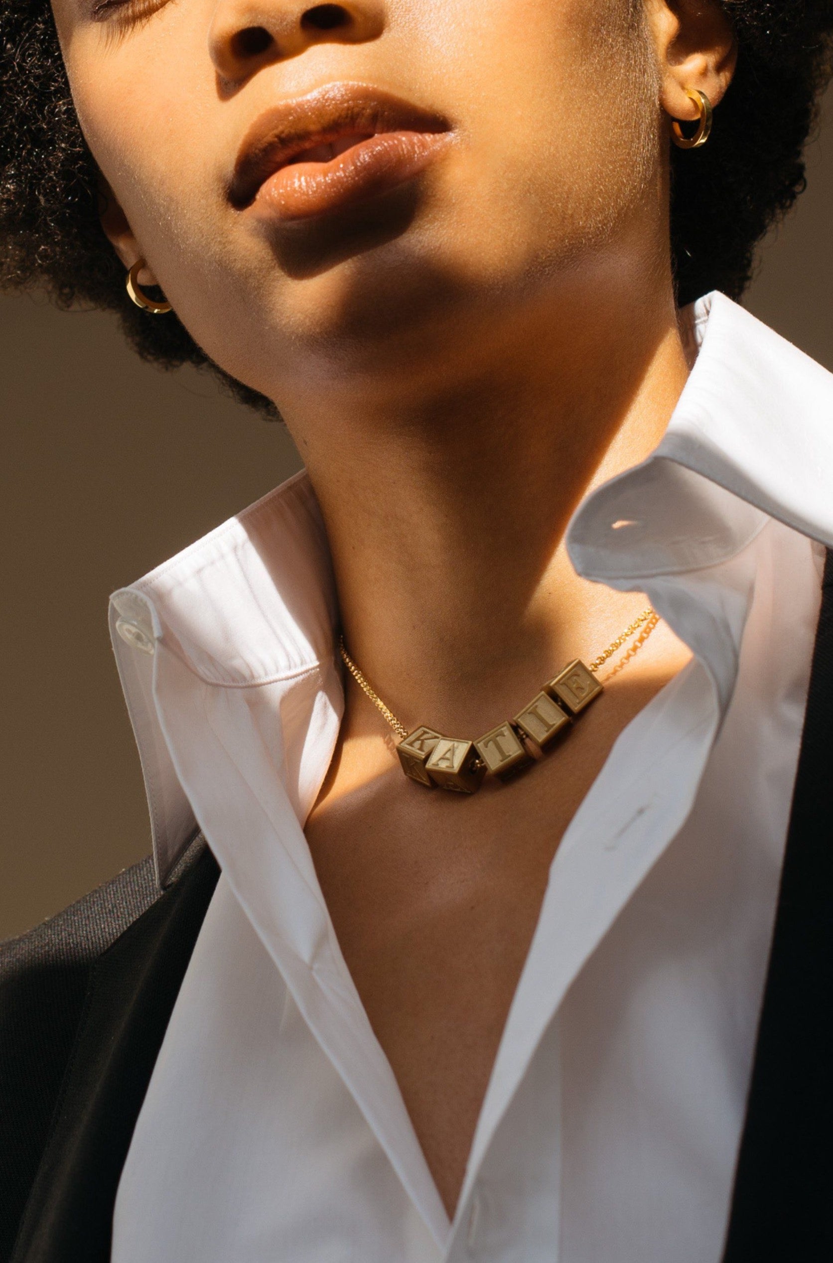 Full view of Model wearing 5 Letter Block letters on chain Bagatiba