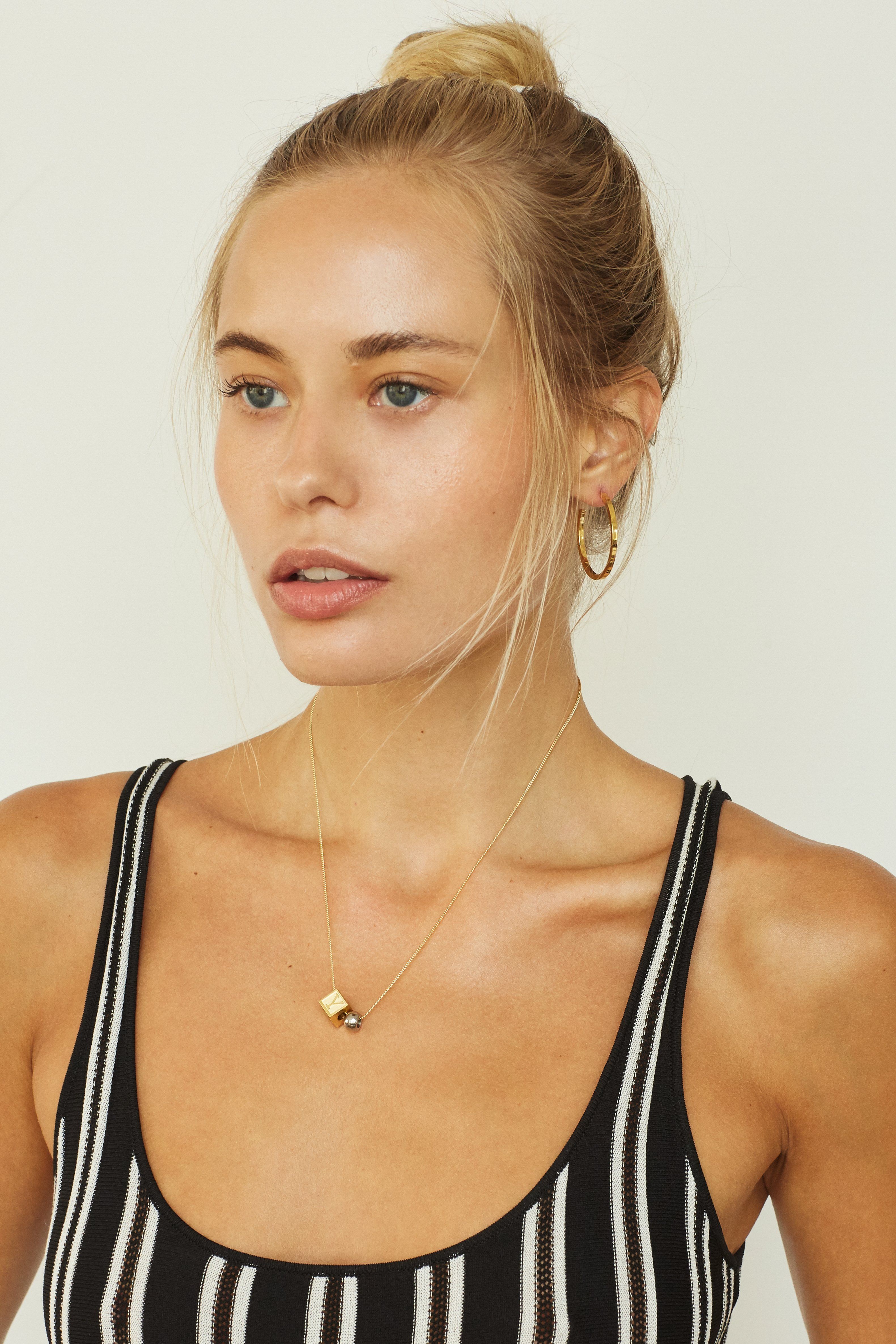 Model wearing "Y" Letter Block letters paired with simple gold hoops Bagatiba 