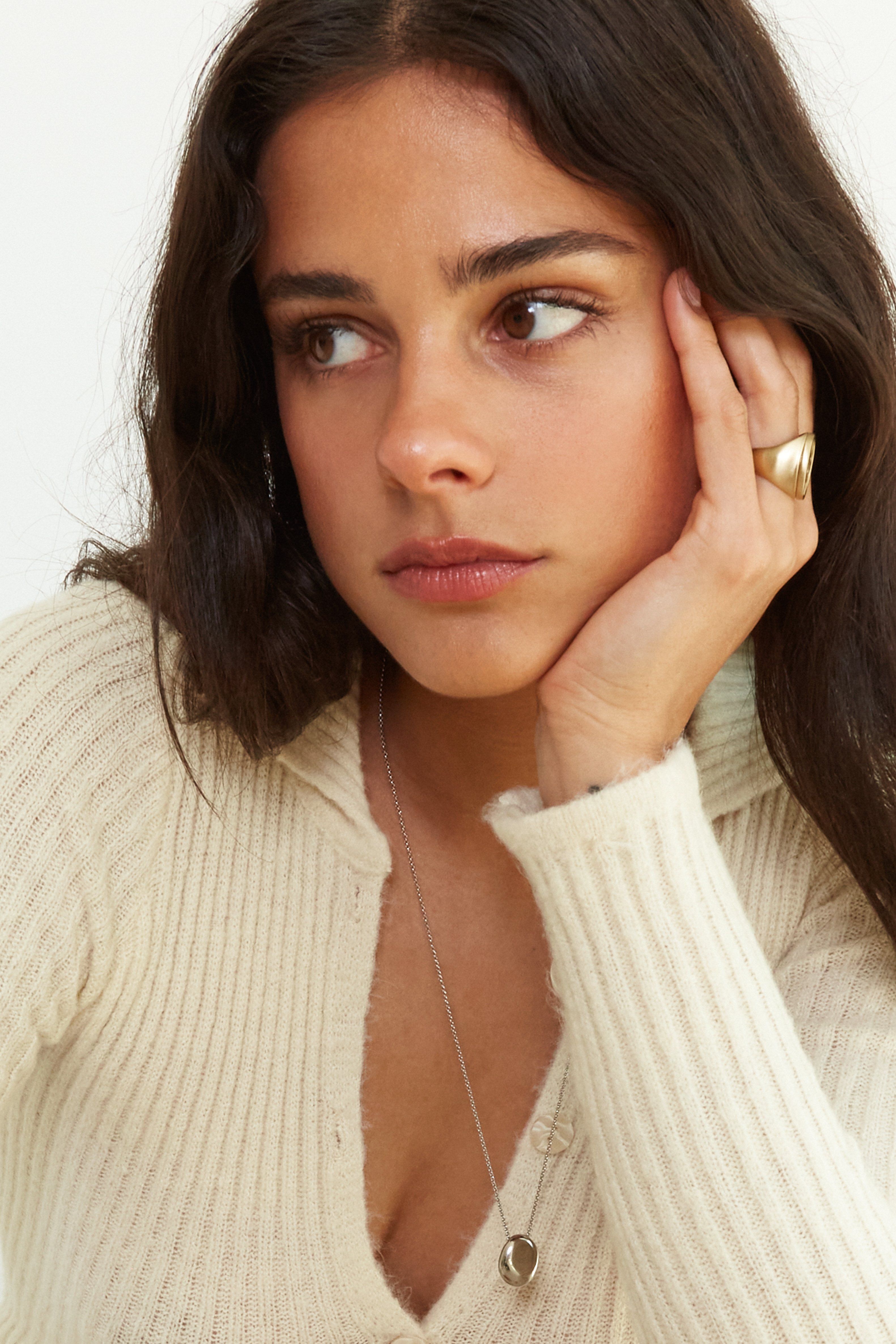 Side view on model's hand of the Yin Yang Glass Ring Necklace bagatiba 