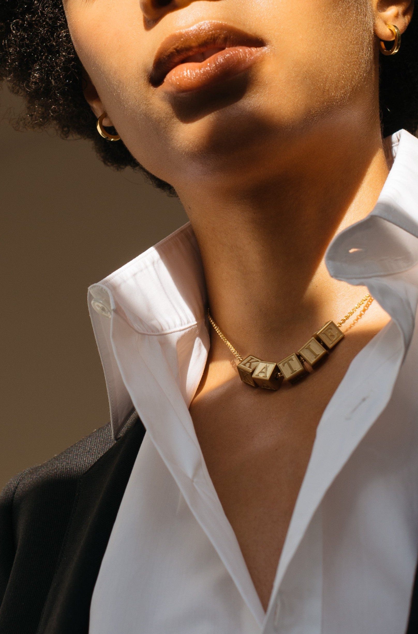 Model wearing 5 Letter Block letters on choker chain Bagatiba